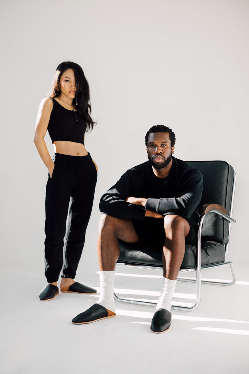 Photo of man and woman wearing Ouive unisex leather house slipper