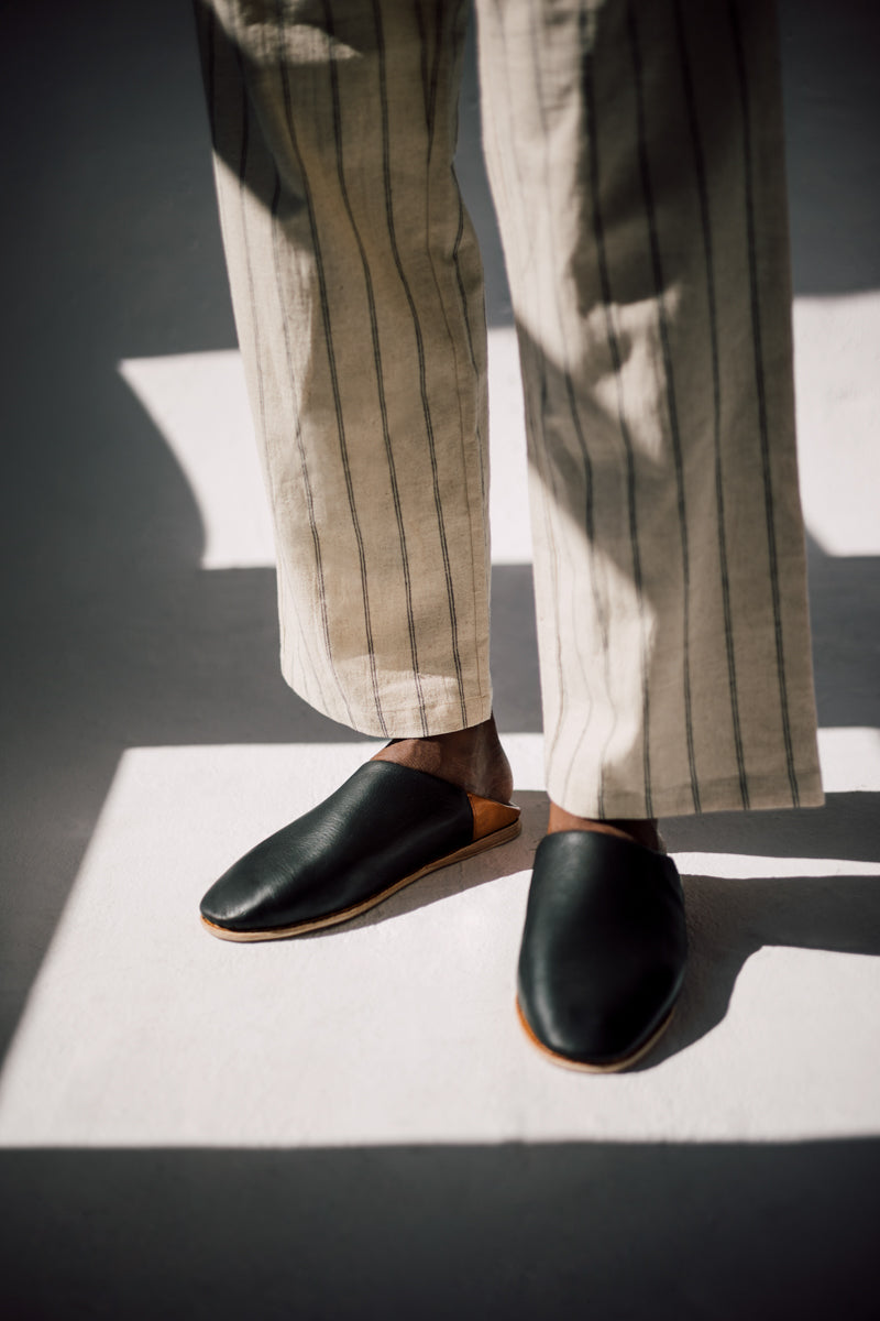 Close up of man wearing Ouive Black Leather slipper
