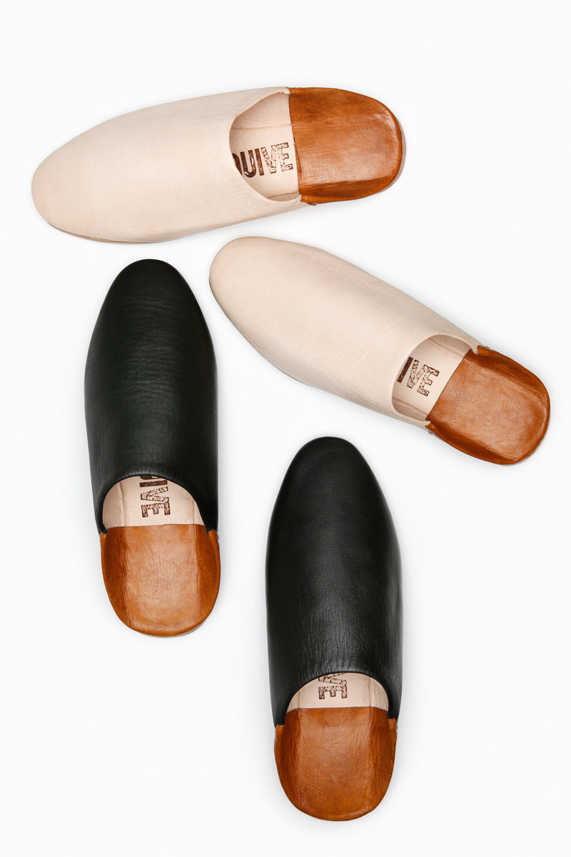 Above shot of Ouive unisex leather house shoe in black and light natural leather with tan heel