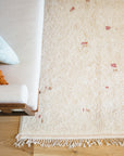 White Moroccan Wool Rug With Beige and Rose Pebble dots in Midcentury Modern Living room