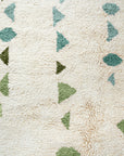 Close up of hand-knotted multishade Green Moroccan Rug with Aqua, forest green and celery green on white