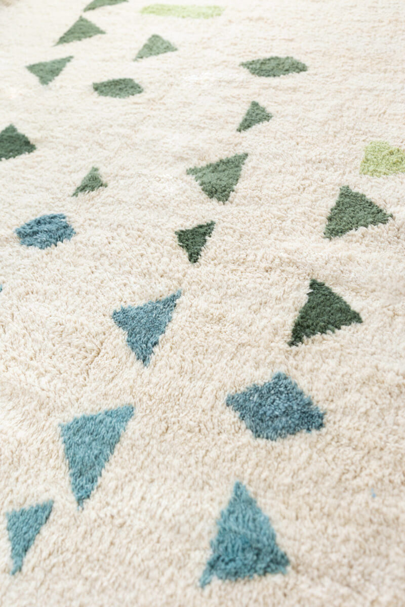 Close up diagonal detail photo of Ouive Jardin Green, Aqua and white Moroccan wool rug