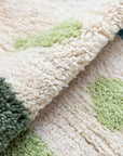 Ouive Jardin rug folded to show texture of hand-knotted wool