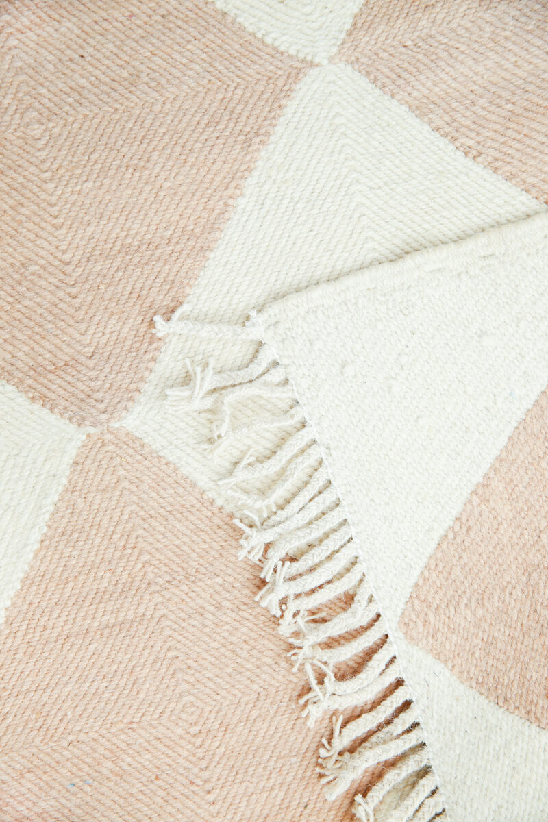 Close-up of Fringe Champagne Blush Checker Zanafi Moroccan Wool Rug