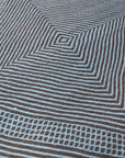 Close up at angle of Light Blue + Charcoal Made-to-order Zanafi Moroccan Wool Rug