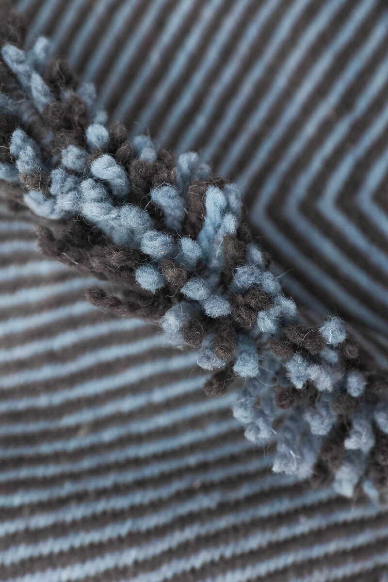 Close up of side fringe of Light Blue + Charcoal Made-to-order Zanafi Moroccan Wool Rug