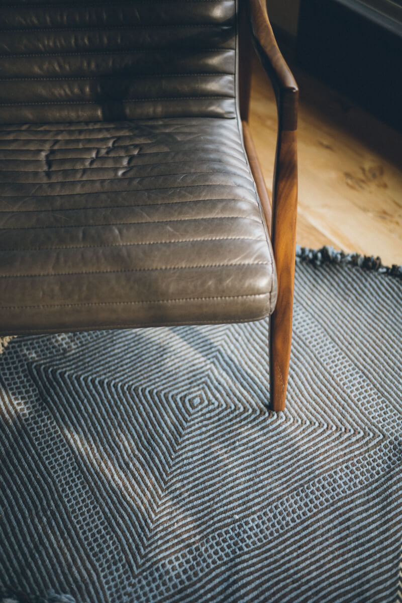 Leather chair with Light Blue + Charcoal Made-to-order Zanafi Moroccan Wool Rug