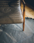Leather chair with Light Blue + Charcoal Made-to-order Zanafi Moroccan Wool Rug