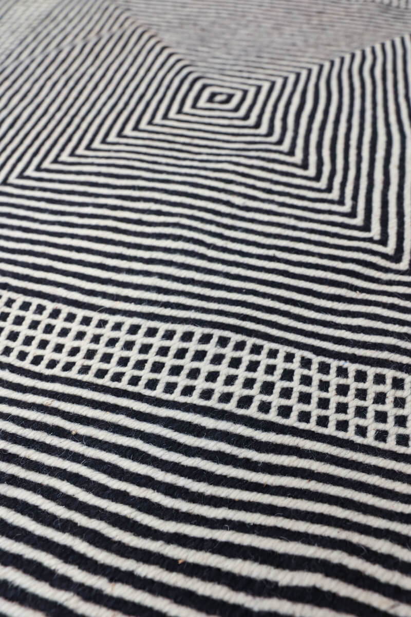 close up at angle of Black + White Made-to-order Zanafi Moroccan Wool Rug