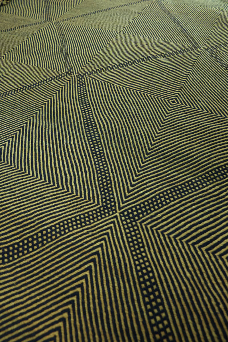 Close up at angle of Black and olive Zanafi Moroccan Wool Rug