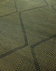 Close up at angle of Black and olive Zanafi Moroccan Wool Rug