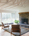Living room with fireplace and flatweave black and olive green Moroccan wool rug