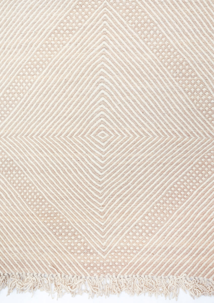 Detail from above of Champagne Blush + White Made-to-order Zanafi Moroccan Wool Rug fringe