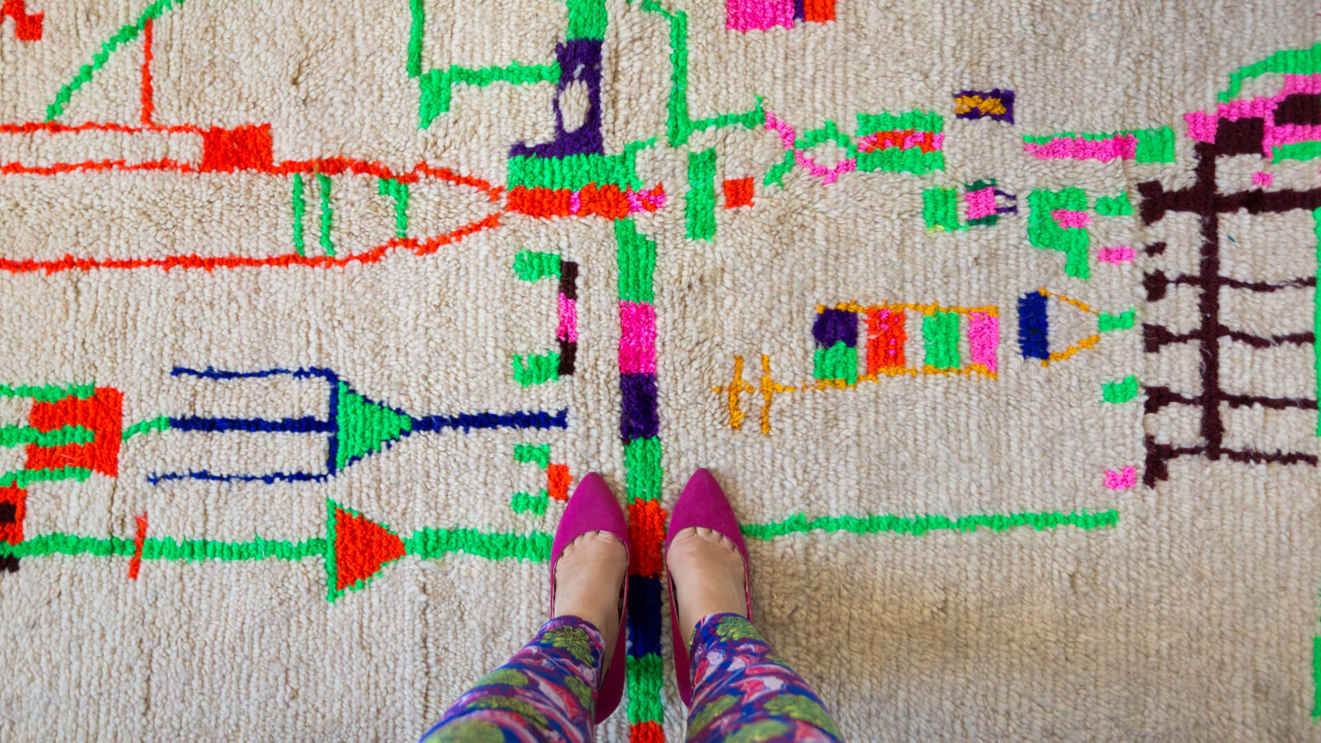 Pink shoes on colorful Moroccan tribal rug