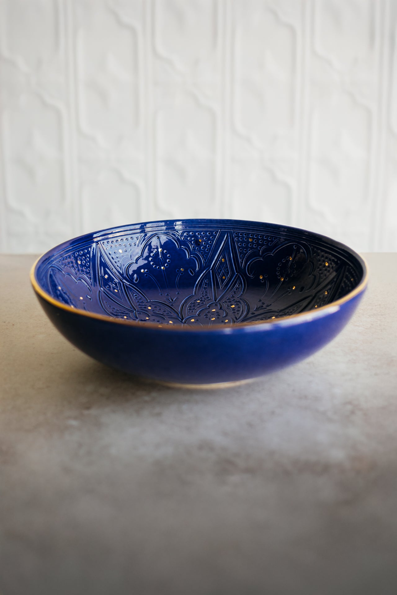 Blue Chabi Chic Empreinte ceramic Moroccan bowl with intricate patterns on a textured surface and white background