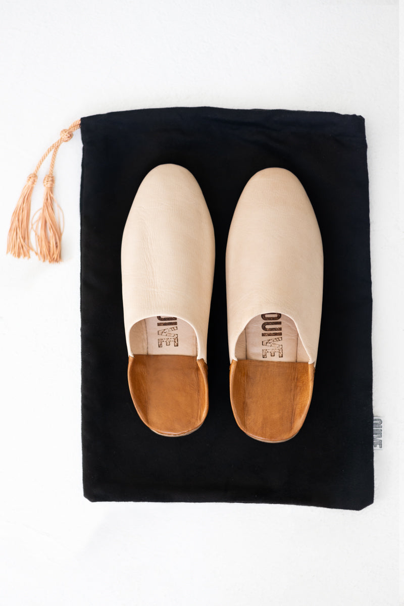 Above shot of Ouive Unisex House Shoe in Light Natural undyed leather with black drawstring travel bag