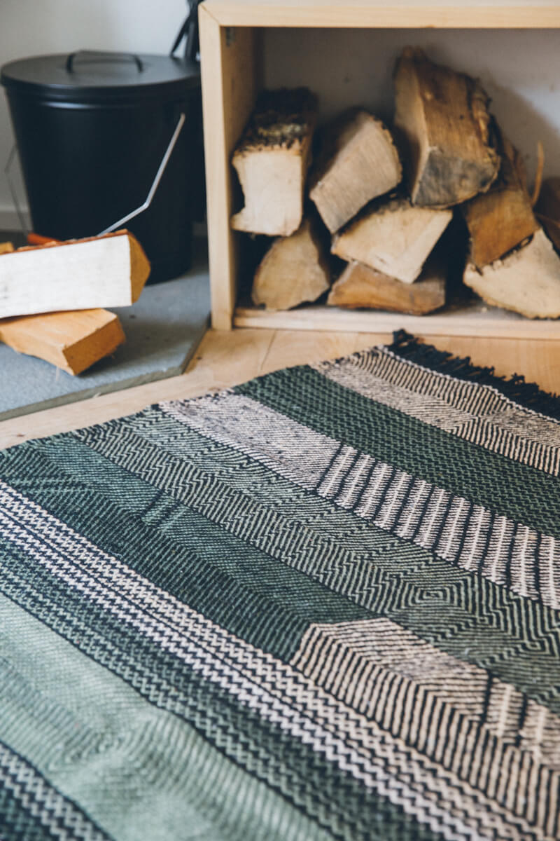 Striped Chadoui Zanafi - Forrest - Flatweave Moroccan Rug infront of firewood