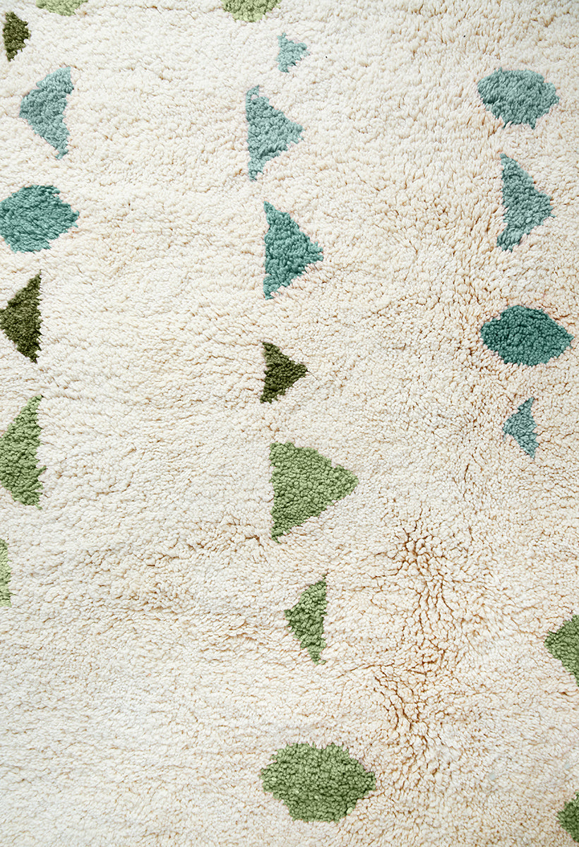 Close up of hand-knotted multishade Green Moroccan Rug with Aqua, forest green and celery green on white