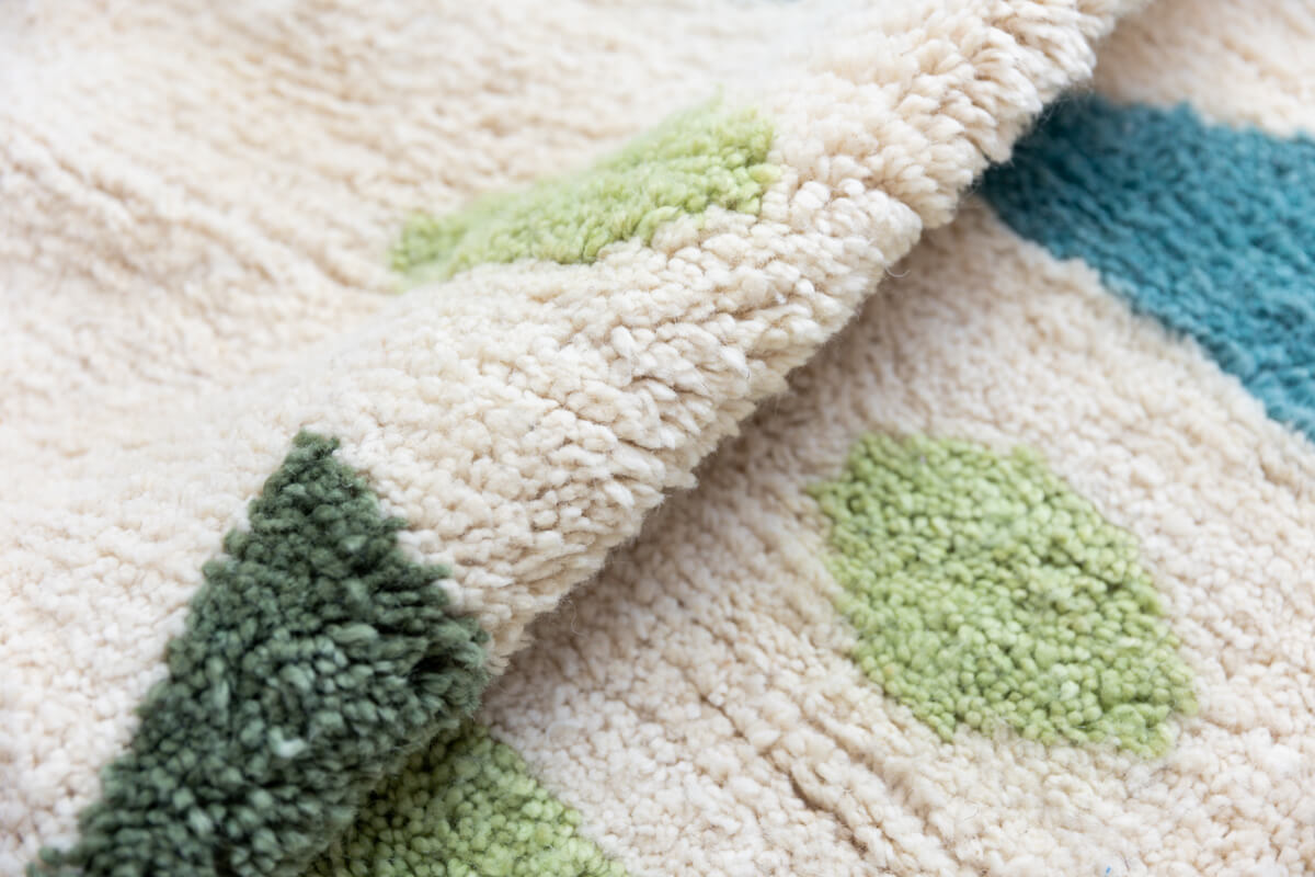 Ouive Jardin rug folded to show texture of hand-knotted wool