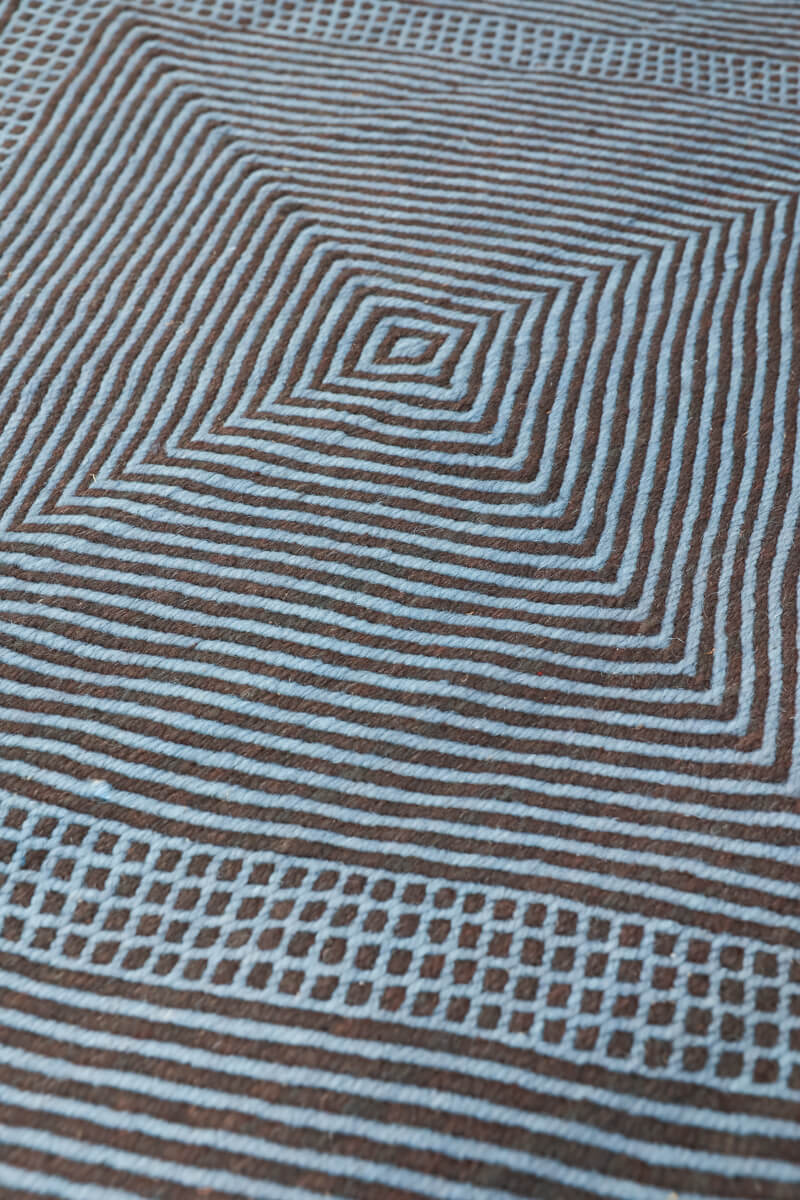 Close up at angle of Light Blue + Charcoal Made-to-order Zanafi Moroccan Wool Rug