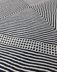 close up at angle of Black + White Made-to-order Zanafi Moroccan Wool Rug