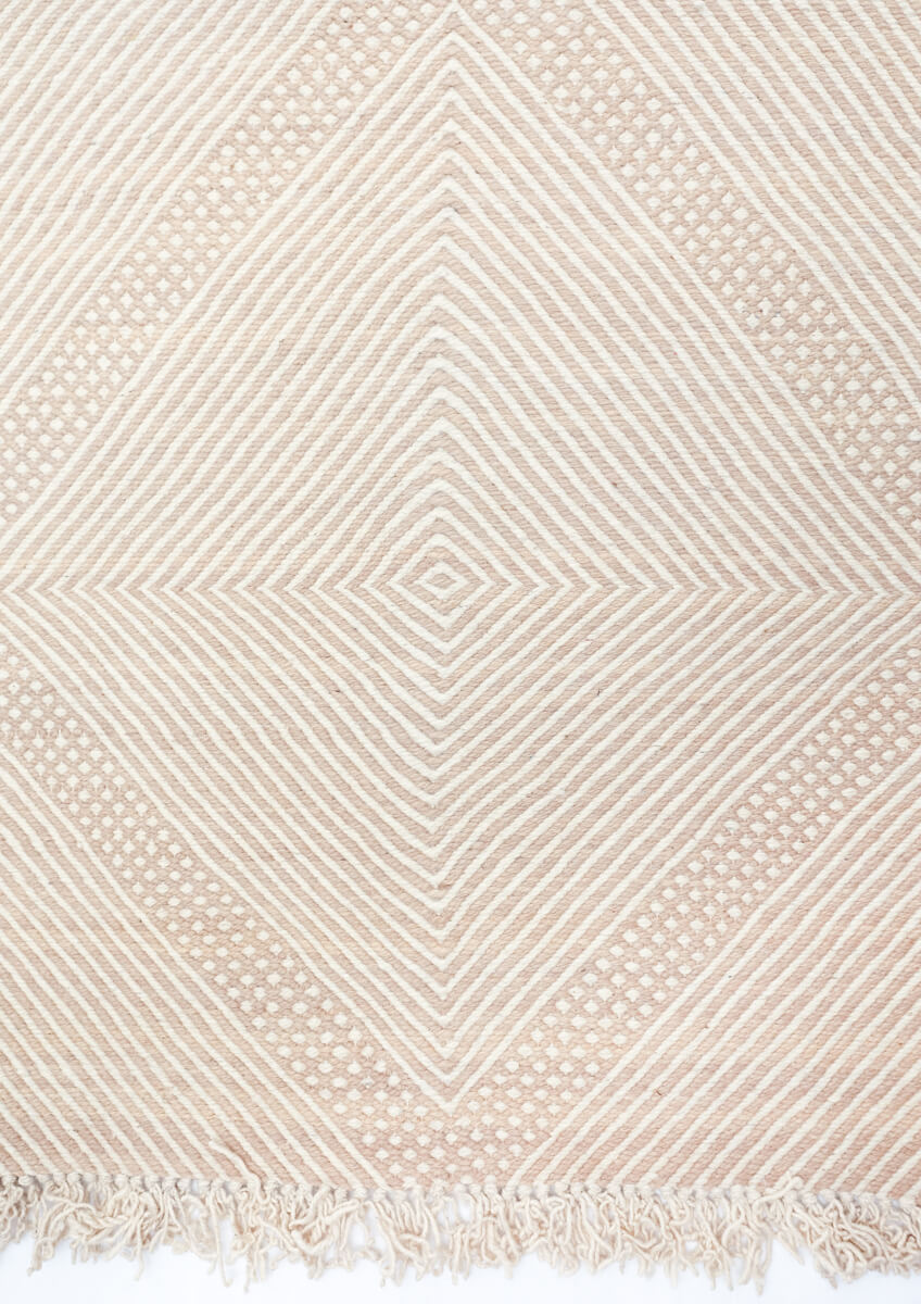 Detail from above of Champagne Blush + White Made-to-order Zanafi Moroccan Wool Rug fringe