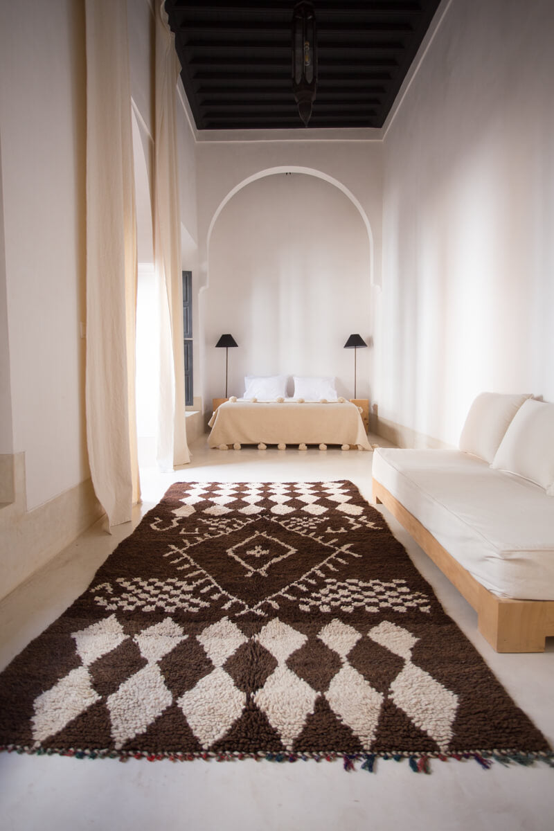 Vintage brown Moroccan rug in minimalist bedroom