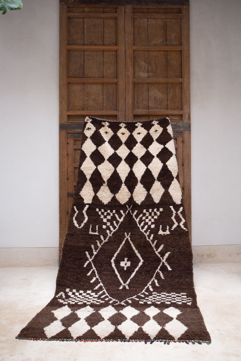 Vintage handmade dark brown Boujad Moroccan rug with tribal symbols