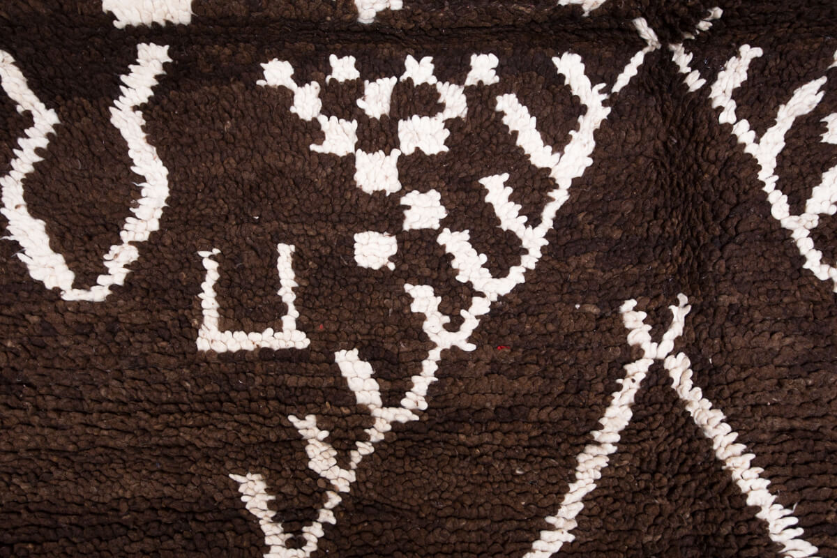 Close up of tribal symbols on wool rug