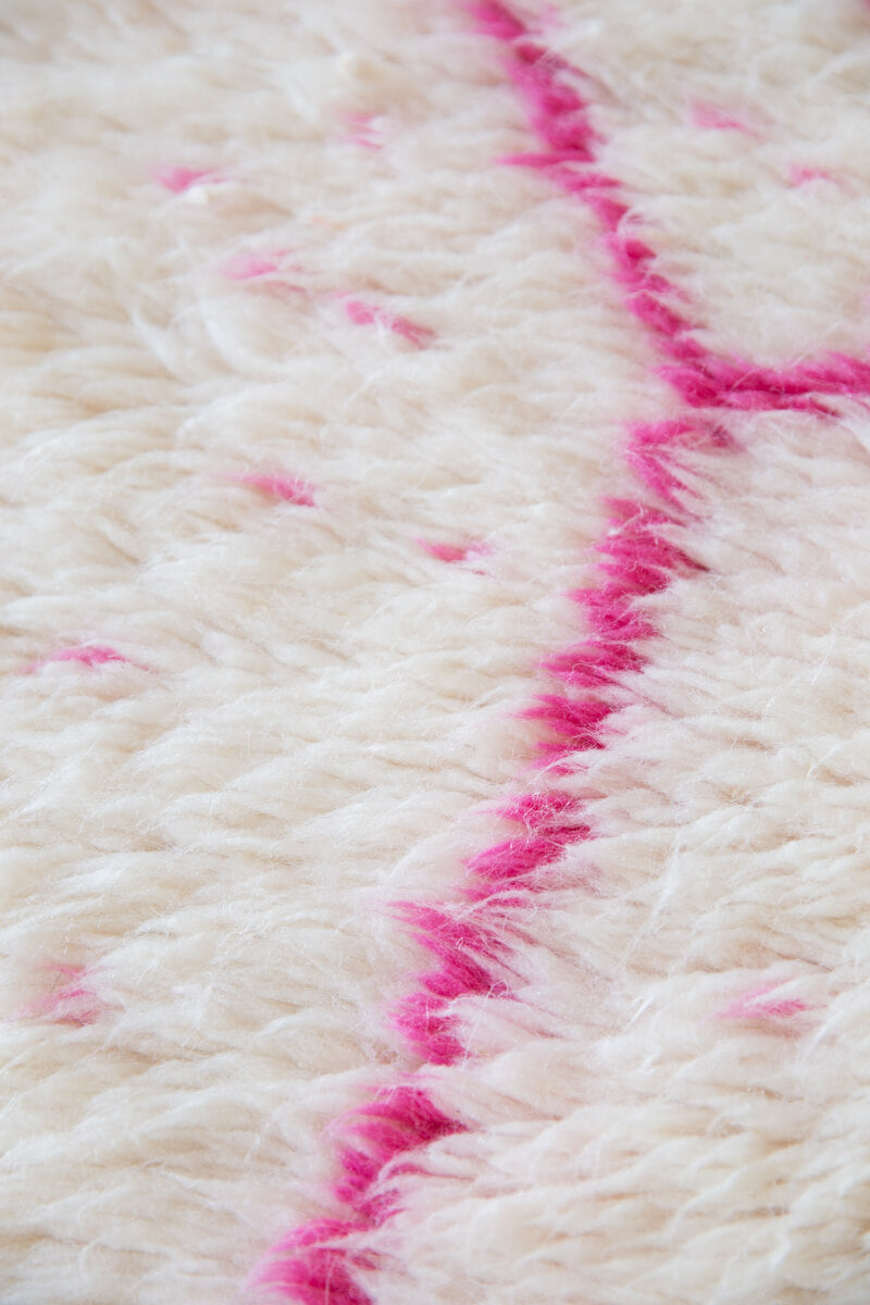 close up of pink and white area rug